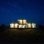Canon City Container Cabin lit up night view 1