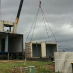 bushland beach container home construction crane