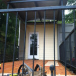 hinckle container home construction through railing