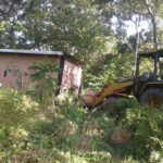 roatan container cabins backhoe moving