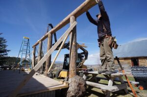 placing the horizontal beam for the cabin porch support