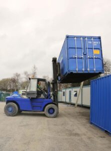 Forklift moving a container