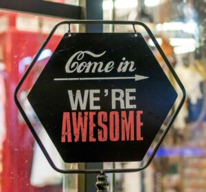 come in we're awesome sign